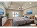 Spacious bedroom featuring a ceiling fan, a large window, and recessed lighting at 129 Elite Way, Mcdonough, GA 30252