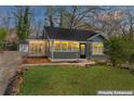 Charming home with a screened-in porch and landscaped front yard at 19 Grove Park Nw Pl, Atlanta, GA 30318