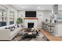 Bright living room featuring a decorative fireplace, stylish furniture, and an open concept at 19 Grove Park Nw Pl, Atlanta, GA 30318