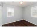 Cozy bedroom featuring two windows for natural light and a closet for storage and dark wood floors at 491 Bolton Nw Rd, Atlanta, GA 30331