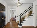 Elegant foyer boasts gleaming hardwood floors, staircase, and a view into a dining room at 435 Collier Nw Rd, Atlanta, GA 30309