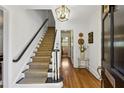 Welcoming entryway features a staircase with hardwood floors and a stylish light fixture at 435 Collier Nw Rd, Atlanta, GA 30309