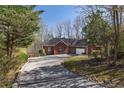 Beautiful red brick home with manicured lawn, shrubs and driveway at 5060 Governors Walk Dr, Canton, GA 30115