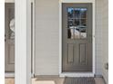 Stylish front door with glass panels providing natural light to the entry area with modern details at 5890 Vinyard Ln, Cumming, GA 30041