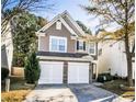 Charming two-story home featuring a two-car garage and a manicured front yard at 946 Gardenia Curv, Canton, GA 30114