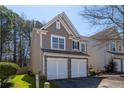 Charming two-story home showcasing neutral siding, stone accents, and a convenient two-car garage at 946 Gardenia Curv, Canton, GA 30114