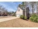 Side exterior view showing the driveway and attached two-car garage at 2002 Stonewick Ct, Lawrenceville, GA 30043