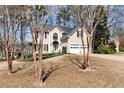 Beautiful two-story home with a well-maintained lawn and mature trees at 2002 Stonewick Ct, Lawrenceville, GA 30043