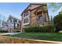 Inviting two-story home with stone accents, manicured landscaping, and driveway at 2108 Main Nw St, Atlanta, GA 30318