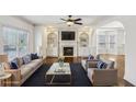 Staged living room features a fireplace, custom built-ins, and a large window at 2108 Main Nw St, Atlanta, GA 30318