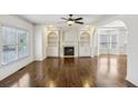 Living room features a fireplace, custom built-ins, and gleaming hardwood floors at 2108 Main Nw St, Atlanta, GA 30318