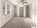 Inviting living room with neutral carpeting, a ceiling fan, and plenty of natural light from the window at 2203 Knoll Dr, Decatur, GA 30032