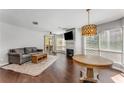 Sunlit living room with a cozy sofa, stylish coffee table, fireplace, and hardwood floors at 244 13Th Ne St # 302, Atlanta, GA 30309