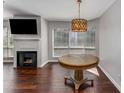 Living room with a fireplace, mounted TV, hardwood floors and an unique decorative light fixture at 244 13Th Ne St # 302, Atlanta, GA 30309