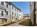 A street view between townhomes featuring brick and siding facades with landscaped islands at 3165 Dogwood Dr # 107, Hapeville, GA 30354