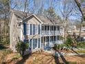 Two-story home featuring a double porch with white railings, complemented by classic blue shutters at 1522 Wood Valley Dr, Marietta, GA 30066