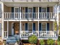 Inviting double porch with white railings and classic blue shutters create a welcoming entrance at 1522 Wood Valley Dr, Marietta, GA 30066