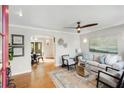 Bright living room with hardwood floors, a ceiling fan, and comfortable seating at 966 Tilden Nw St, Atlanta, GA 30318