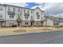 Inviting townhouse row with classic architectural details, brick accents, and a well-maintained front lawn at 1273 Harvest Park Ln, Suwanee, GA 30024