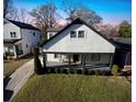 Lovely two-story home with a welcoming porch, complemented by manicured greenery and an adjacent driveway at 1583 Elixir Sw Ave, Atlanta, GA 30314