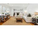 Bright living room with hardwood floors, large sofa, and shuttered windows at 2173 Lebaron Ne Dr, Atlanta, GA 30345