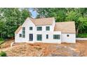 Beautiful white brick home exhibits contemporary architecture with a wood shingle roof and dark trim windows at 2983 Habersham Nw Ct, Atlanta, GA 30305