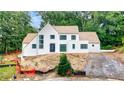 Charming white brick home features a modern design, dark trimmed windows and a newly installed driveway at 2983 Habersham Nw Ct, Atlanta, GA 30305