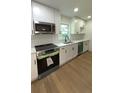 Bright kitchen features stainless appliances, white cabinets, and a double basin sink at 4373 Sun Valley Blvd, Atlanta, GA 30344