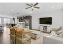 Bright living room featuring hardwood floors, modern lighting, comfortable seating, and an open layout to the kitchen at 1181 Rambler Cross, Atlanta, GA 30312