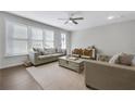 Bright living room with large windows, comfortable seating, and a stylish ceiling fan at 1181 Rambler Cross, Atlanta, GA 30312