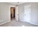 Inviting bedroom featuring neutral walls, carpet, and a closet with an open door to the hallway at 4751 Lorient Ct, Snellville, GA 30039