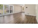A spacious living room features new flooring, neutral paint, and bright natural light at 2254 Whites Mill Rd, Decatur, GA 30032