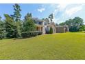 Spacious front yard showcasing a well-maintained lawn and mature trees surrounding the home at 4408 Meadowwood Dr, Loganville, GA 30052