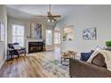 Bright living room with vaulted ceiling, fireplace, wood floors, and lots of natural light at 1620 Rising Mist Ln, Cumming, GA 30041