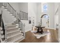 Grand foyer featuring high ceilings, wood floors, and a staircase with a metal railing at 2758 Chieftain Run, Duluth, GA 30097