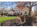 Inviting exterior view of a home featuring mature trees and beautiful landscaping around the property at 700 Clubside Dr, Roswell, GA 30076