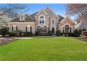 Attractive front exterior of a two story home with a well-manicured lawn and mature landscaping at 700 Clubside Dr, Roswell, GA 30076