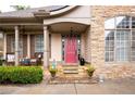 Inviting front porch with stone accents and comfortable seating area at 1976 Hedge Brooke Nw Trl, Acworth, GA 30101