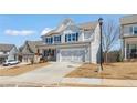 New two-story home featuring a driveway, beautiful siding, and landscaping at 162 Spaulding Ln, Woodstock, GA 30188