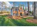 Inviting two-story brick house with lush landscaping and a neatly maintained lawn at 4506 Reva Ne Way, Marietta, GA 30066