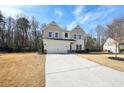 Inviting two-story home with board and batten siding, featuring an attached two-car garage and spacious front yard at 4825 Marco Ln, Cumming, GA 30028