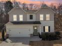 Charming home showcasing board and batten siding, a two-car garage, and complemented by a well-maintained lawn at 4825 Marco Ln, Cumming, GA 30028