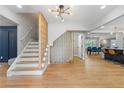 Bright foyer featuring hardwood floors, decorative staircase, and an open floor plan to the kitchen and dining areas at 2672 Langland Ne Ct, Atlanta, GA 30345