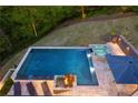 Stunning aerial view of the inground pool and spa highlighting the outdoor lounge area at 2672 Langland Ne Ct, Atlanta, GA 30345
