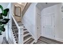 Staircase featuring black iron railings, neutral decor, and access to upper levels at 2698 Ne Almand Ln, Conyers, GA 30013