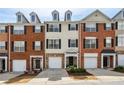 A row of brick and siding townhomes with individual garages and private entrances at 3736 Chattahoochee Summit Se Dr # 20, Atlanta, GA 30339