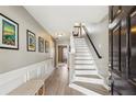 Inviting foyer with wood floors, stairs, and wall art, leading to other areas of the home at 3736 Chattahoochee Summit Se Dr # 20, Atlanta, GA 30339