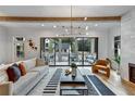 Living room featuring hardwood floors, modern lighting, and sliding glass doors to the outdoor deck at 2171 James Aly, Atlanta, GA 30345
