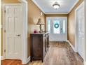 Bright foyer featuring hardwood floors, front door with decorative glass, and accent table at 3075 Wood Valley Dr, Mcdonough, GA 30253