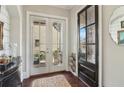 Bright entryway with dark wood floors, stylish doors, and elegant decor at 4224 Dogwood Bend Park, Duluth, GA 30096